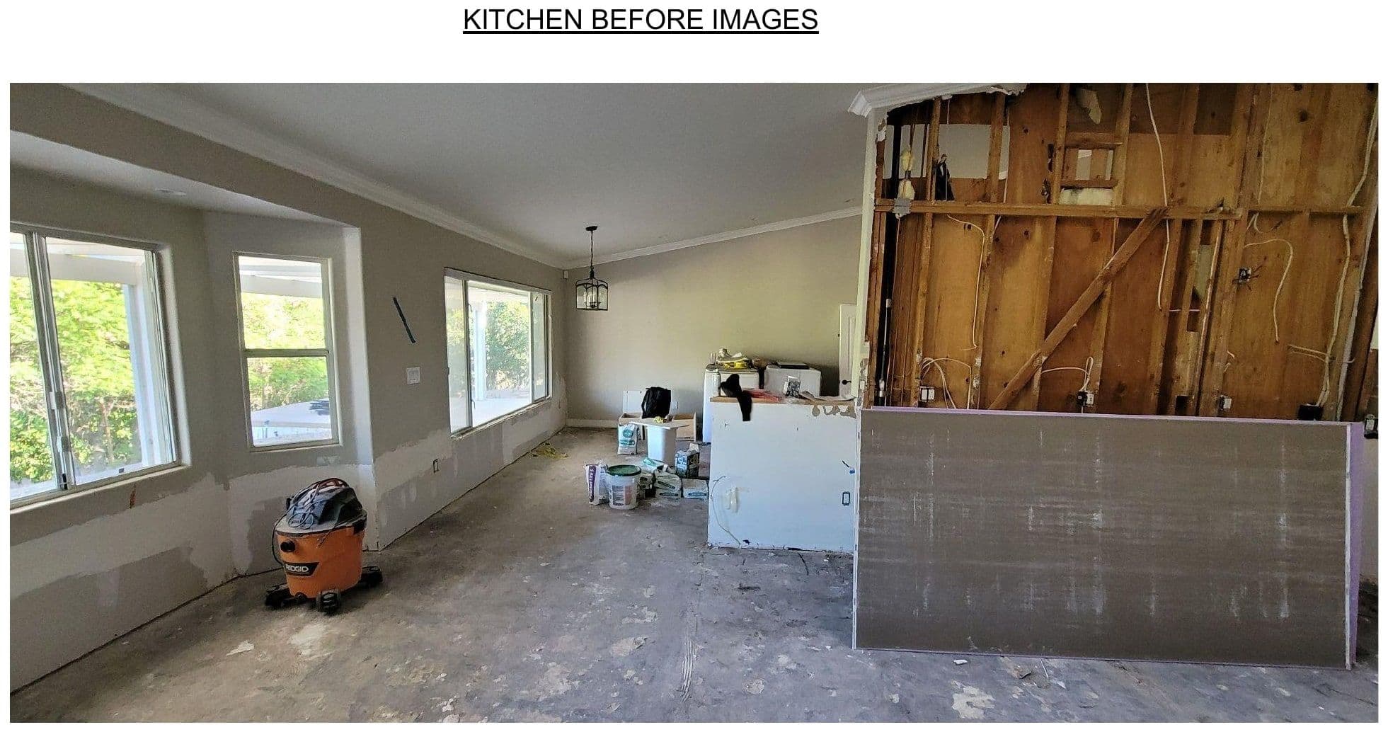 Demolition photograph — interior taken back to studs, exposed framing, sub-floor.